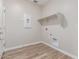 Functional laundry room showcasing tiled floor, shelf, and utility connections at 7229 E Cattle Call St, San Tan Valley, AZ 85143