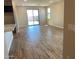 Bright living room with tile flooring, sliding glass doors to the backyard, and neutral wall colors at 7229 E Cattle Call St, San Tan Valley, AZ 85143