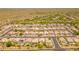 Aerial view of a neatly planned community featuring tiled roof homes, solar panels, and lush desert landscaping at 7297 E Black Rock Rd, Scottsdale, AZ 85255