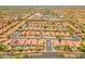An aerial view showing rows of tile roof homes, desert landscaping, and community streets and pools at 7297 E Black Rock Rd, Scottsdale, AZ 85255