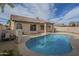 Inviting backyard featuring a refreshing pool, tan patio, privacy wall, and well-maintained landscaping at 7297 E Black Rock Rd, Scottsdale, AZ 85255