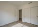 An empty bedroom with tile flooring, open closet, and neutral walls for versatile decorating at 7297 E Black Rock Rd, Scottsdale, AZ 85255
