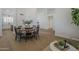 Spacious dining room with round wooden table, black chairs, and tile flooring, open to additional living spaces at 7297 E Black Rock Rd, Scottsdale, AZ 85255