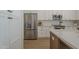 Modern kitchen with stainless steel appliances, white cabinets, and an island with quartz countertop at 7297 E Black Rock Rd, Scottsdale, AZ 85255