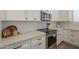 Bright kitchen with modern appliances, white cabinets, and sleek quartz countertops at 7297 E Black Rock Rd, Scottsdale, AZ 85255