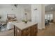 Kitchen island with white countertop, dark wood cabinets, and view into living and dining areas at 7297 E Black Rock Rd, Scottsdale, AZ 85255