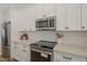 White cabinets, stainless steel appliances, and quartz countertops outfit the kitchen at 7297 E Black Rock Rd, Scottsdale, AZ 85255