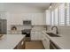 Modern kitchen featuring stainless steel appliances, white cabinets, and updated countertops at 7297 E Black Rock Rd, Scottsdale, AZ 85255