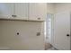 A laundry room with white cabinets, neutral flooring, washer hook ups, and plenty of storage space at 7297 E Black Rock Rd, Scottsdale, AZ 85255