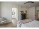 Bright bedroom with view to ensuite bath featuring ceiling fan and modern decor at 7297 E Black Rock Rd, Scottsdale, AZ 85255