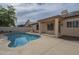 Backyard pool with tan patio, covered area, privacy fence, and desert landscaping, perfect for outdoor relaxation at 7297 E Black Rock Rd, Scottsdale, AZ 85255