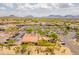 Aerial view of a neighborhood shopping center with ample parking and desert landscaping and nearby mountain views at 7297 E Black Rock Rd, Scottsdale, AZ 85255