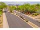 A street view of the subdivision entrance with lush desert landscaping and mountain views in the background at 7297 E Black Rock Rd, Scottsdale, AZ 85255