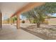 Covered back patio offering shade and views of the low-maintenance backyard at 7546 W Mary Jane Ln, Peoria, AZ 85382