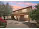 Backyard with covered patio, desert landscaping, and mature trees providing shade and privacy at 7546 W Mary Jane Ln, Peoria, AZ 85382