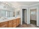 Bathroom featuring double sinks, a large mirror, and access to an additional room at 7546 W Mary Jane Ln, Peoria, AZ 85382