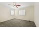 Empty bedroom with carpet flooring, a ceiling fan, and white plantation shutters at 7546 W Mary Jane Ln, Peoria, AZ 85382