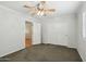 Bedroom featuring carpet flooring, a ceiling fan, and closet with mirrored sliding doors at 7546 W Mary Jane Ln, Peoria, AZ 85382