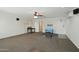 Large bonus room features neutral carpeting, a ceiling fan, and built-in speakers at 7546 W Mary Jane Ln, Peoria, AZ 85382