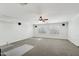 Spacious bonus room featuring neutral carpeting, a ceiling fan, and bright natural light at 7546 W Mary Jane Ln, Peoria, AZ 85382