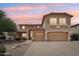 Two-story home featuring a three car garage and a well-maintained desert landscape at 7546 W Mary Jane Ln, Peoria, AZ 85382