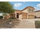 Two-story home with desert landscaping, a three-car garage, and an inviting front entrance at 7546 W Mary Jane Ln, Peoria, AZ 85382