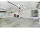 Spacious garage with epoxy flooring, ample storage space, and overhead lighting at 7546 W Mary Jane Ln, Peoria, AZ 85382