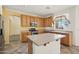 Bright kitchen featuring stainless steel appliances, an island, wood cabinets and tile floors, offering ample counter space at 7546 W Mary Jane Ln, Peoria, AZ 85382