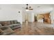 Open-concept living space with tiled floors seamlessly connecting the living room to the kitchen and dining area at 7546 W Mary Jane Ln, Peoria, AZ 85382