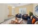 Inviting living room with blue armchairs, stylish decor, white shutters and neutral walls, creating a cozy atmosphere at 7546 W Mary Jane Ln, Peoria, AZ 85382