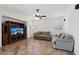 Cozy living room featuring a built-in entertainment center, tiled floors, and comfortable seating at 7546 W Mary Jane Ln, Peoria, AZ 85382