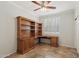 Office space with built-in shelving, a desk, wood accents and tile floors, perfect for a home workspace at 7546 W Mary Jane Ln, Peoria, AZ 85382