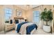 Comfortable bedroom with plush bedding, matching nightstands and lamps, a neutral color scheme, and large window for natural light at 8149 E Petunia Ave # 1007, Mesa, AZ 85212