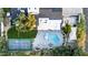 Aerial view of backyard featuring a kidney shaped pool, lounge chairs, and tennis court at 8230 E Wood Dr, Scottsdale, AZ 85260