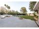 Expansive backyard featuring a patio, pool, sports court, and lounge areas for luxurious outdoor living at 8230 E Wood Dr, Scottsdale, AZ 85260