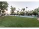 Sprawling backyard featuring a basketball court, volleyball net and manicured turf for outdoor activities and entertainment at 8230 E Wood Dr, Scottsdale, AZ 85260