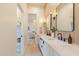 This bathroom showcases a double sink vanity with modern fixtures and stylish honeycomb flooring at 8230 E Wood Dr, Scottsdale, AZ 85260