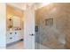 This bathroom offers a modern glass shower, sleek vanity, and stylish lighting fixtures at 8230 E Wood Dr, Scottsdale, AZ 85260
