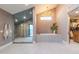 Modern bathroom features a glass shower, soaking tub, and a walk-in closet at 8230 E Wood Dr, Scottsdale, AZ 85260
