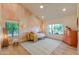 Sun-filled bedroom with decorative lighting, high ceilings and eye-catching accent wall at 8230 E Wood Dr, Scottsdale, AZ 85260