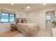 Comfortable bedroom with a ceiling fan, a neutral color palette and a scenic outdoor view at 8230 E Wood Dr, Scottsdale, AZ 85260