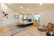 Bright bedroom with canopy bed, wooden floors, and a comfortable seating area at 8230 E Wood Dr, Scottsdale, AZ 85260