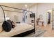 Primary bedroom features a canopy bed, fireplace, and neutral decor at 8230 E Wood Dr, Scottsdale, AZ 85260