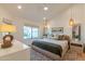 Calm bedroom featuring a ceiling fan, woven pendant lights, and a cozy textured rug at 8230 E Wood Dr, Scottsdale, AZ 85260