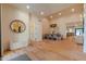 Bright entryway with wood floors, a round mirror, and an inviting bench, leading to the dining area at 8230 E Wood Dr, Scottsdale, AZ 85260