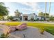 Striking home exterior with meticulous landscaping and a circular driveway showcasing modern design and curb appeal at 8230 E Wood Dr, Scottsdale, AZ 85260