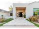 Elegant front entrance with stone pathway, modern chandelier, and sleek design elements at 8230 E Wood Dr, Scottsdale, AZ 85260