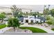 Stunning modern home with unique landscaping and a circular driveway, showcasing its curb appeal at 8230 E Wood Dr, Scottsdale, AZ 85260
