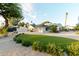 Well-manicured front yard featuring lush landscaping and circular driveway, enhancing the home's curb appeal at 8230 E Wood Dr, Scottsdale, AZ 85260