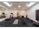 Home gym with skylights, exercise equipment, mirrors, and a durable rubber floor for fitness activities at 8230 E Wood Dr, Scottsdale, AZ 85260